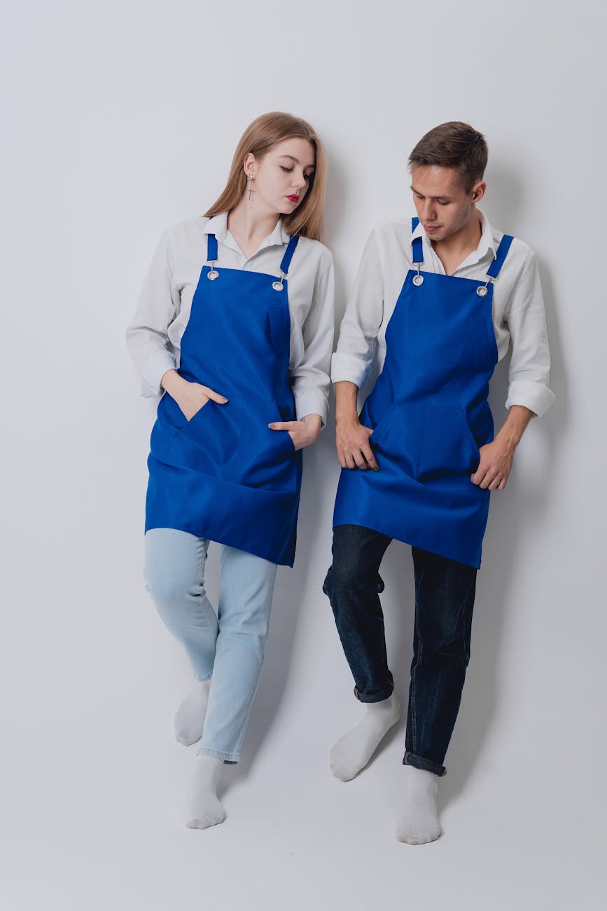 About Us 1 Couple Wearing Blue Aprons