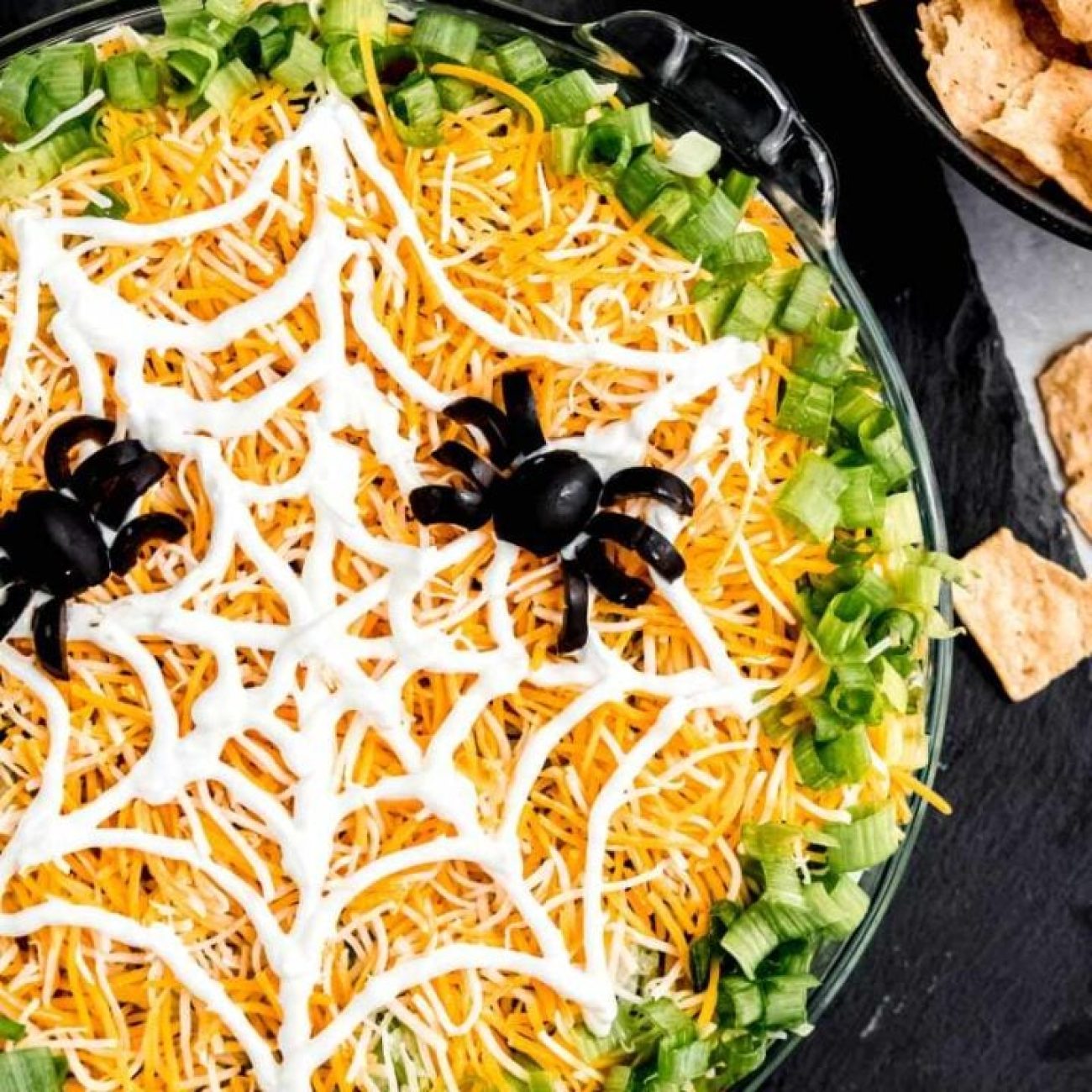 Halloween Spider Web Layered Dip with Creepy Tortilla Chips